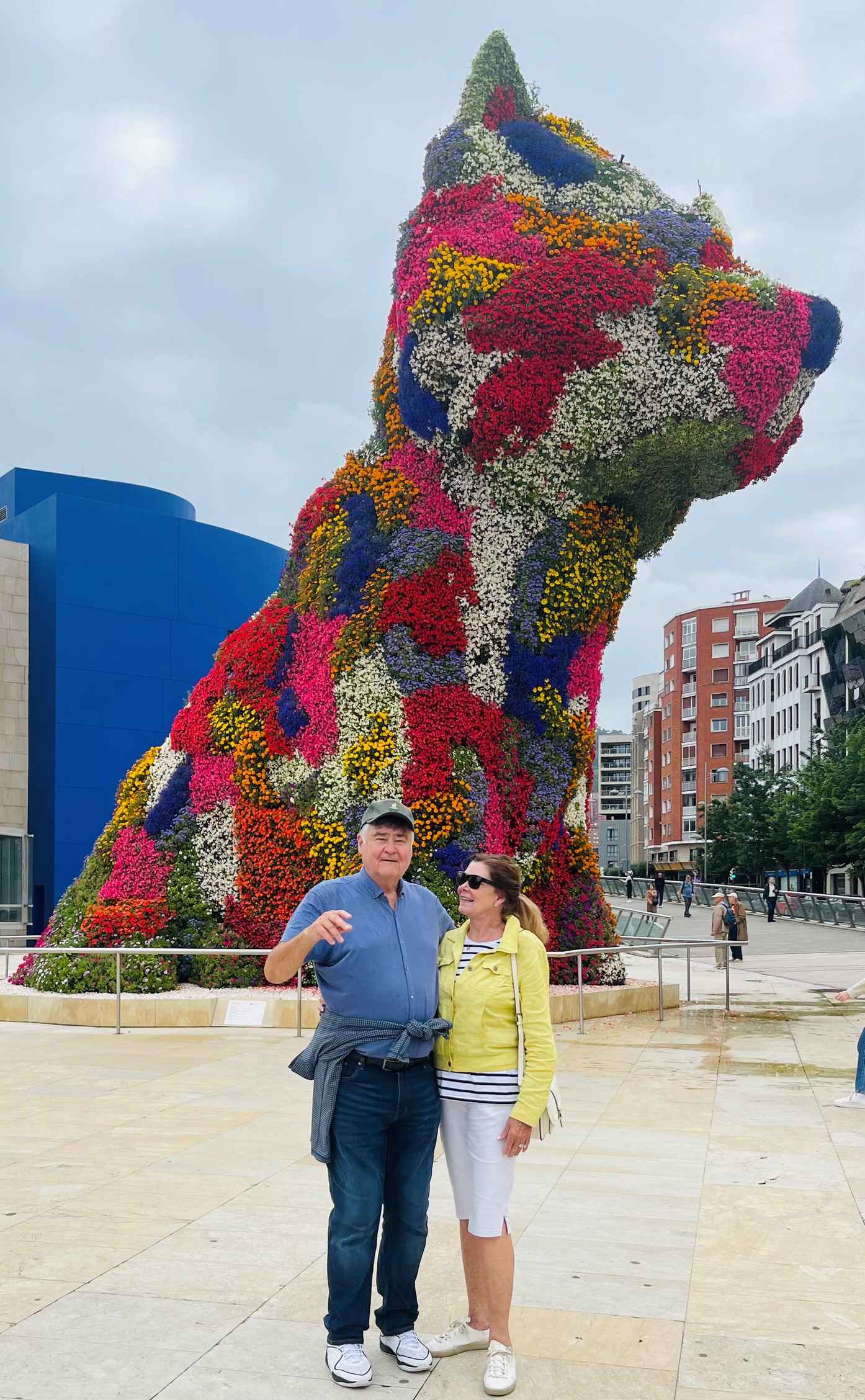 Multi colored flower Guggenheim Dog with Cos and Robin in front in Bilbao, Northern Spain